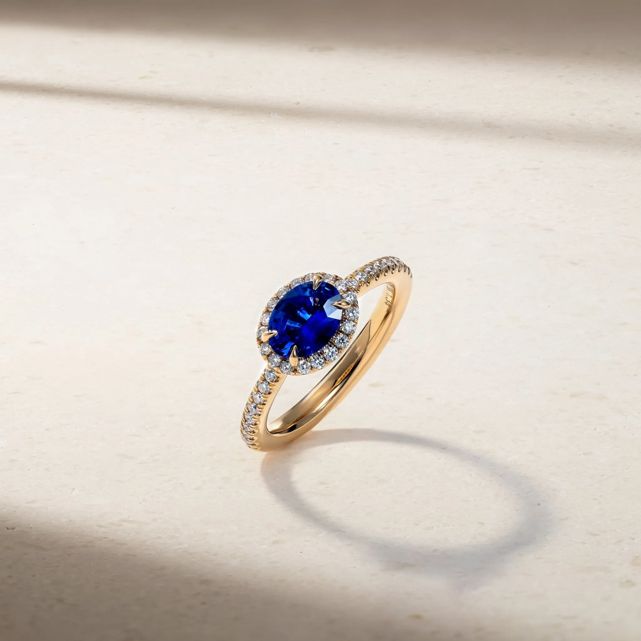 East-West Sapphire and Diamond Halo Ring