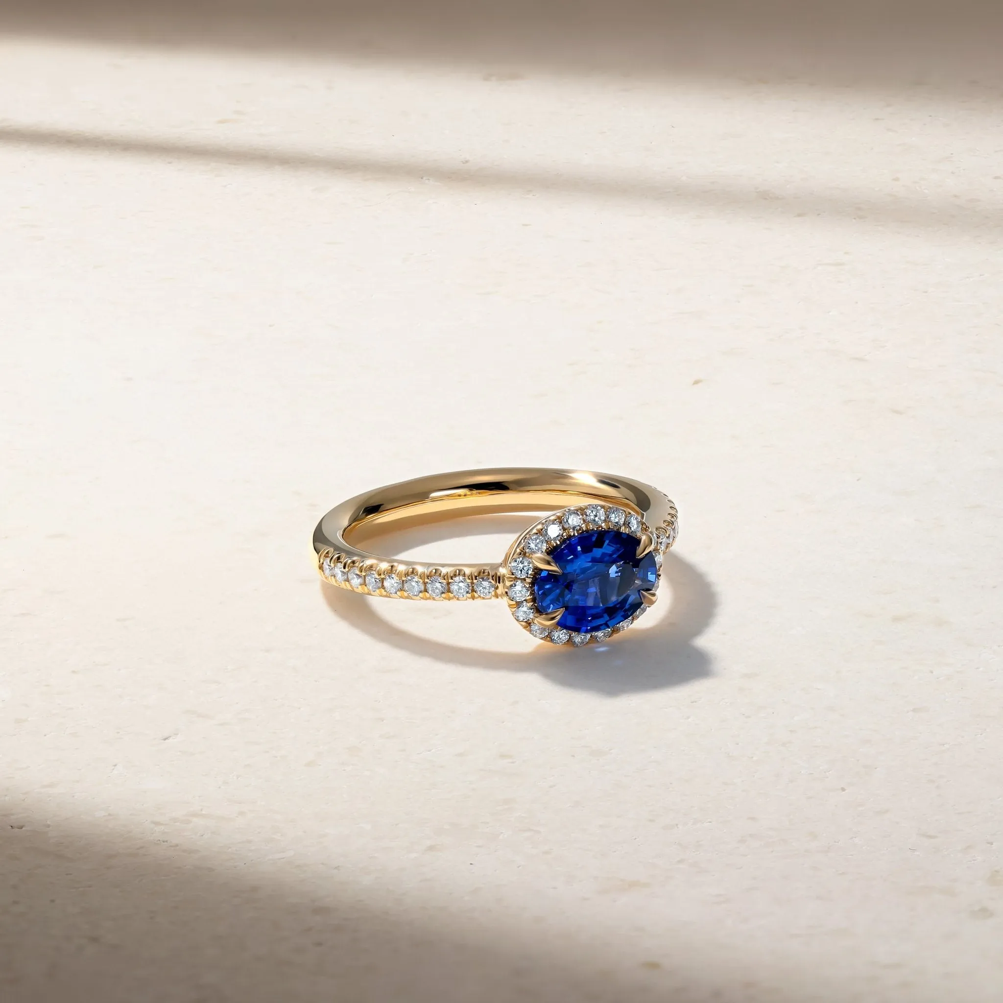 East-West Sapphire and Diamond Halo Ring